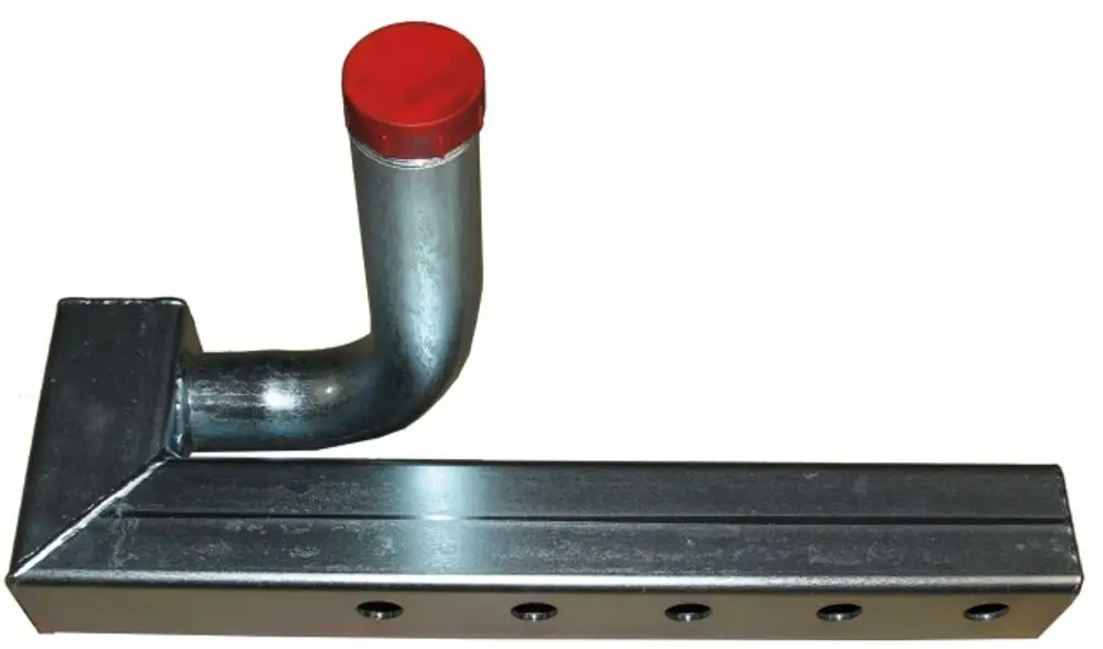Gussblock von Wolf mit einem L-förmigen Ansatz und rotem Deckel. Die Oberfläche ist metallisch und enthält mehrere Bohrungen entlang der längeren Kante.